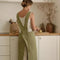 model wearing green criss-cross back apron