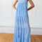 up close of model wearing light blue maxi dress with ruffle hem and white floral print
