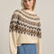 model wearing cream soft sweater with brown and tan nordic print