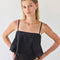 model wearing black handkerchief tank with eyelet floral detail and tie detail