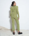 backview of model wearing green tone vertical stripe fuzzy cropped pants with matching zip cardigan