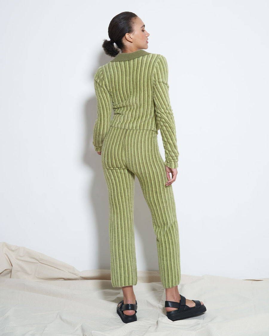 backview of model wearing green tone vertical stripe fuzzy cropped pants with matching zip cardigan