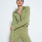 model wearing collar zip-front cropped cardigan with green tone vertical stripes and matching pants