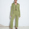model wearing collar zip-front cropped cardigan with green tone vertical stripes and matching pants