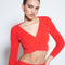 model wearing red furry knit top with criss cross waist and long sleeve