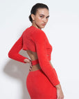 back view of model wearing red furry knit top with criss cross waist and long sleeve