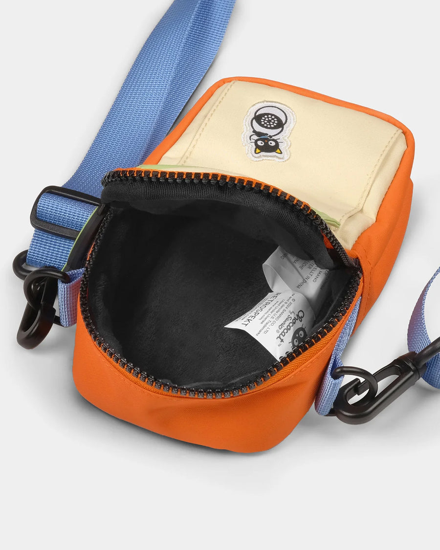 interior of lavender, orange and green color block 35mm camera bag with chococat design