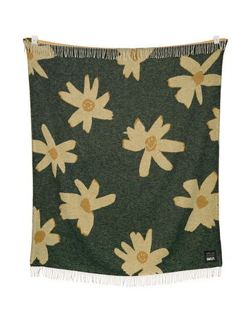 green throw blanket with yellow flower print with smiley faces in the center