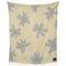 cream throw blanket with periwinkle flower print with smiley faces in the center