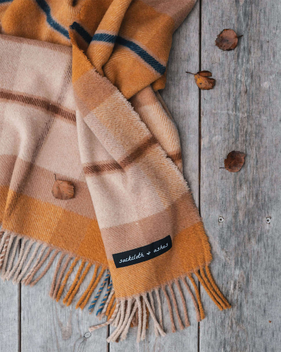 up close of orange and cream plaid throw blanket