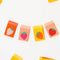 up close of set of 8 multicolor sewing labels with a strawberry in the center