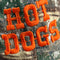 up close of camo dad hat with orange 'HOT DOGS' across the front