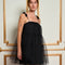 model wearing black tulle tiered mini dress with rosettes on spaghetti straps