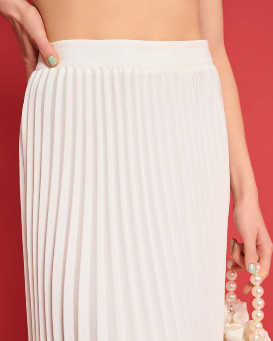 up close of model wearing white pleated midi skirt