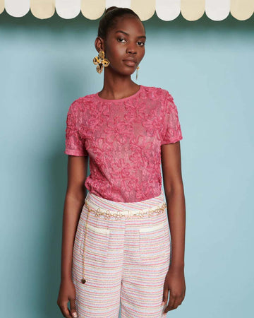 model wearing hot pink top with textured floral print