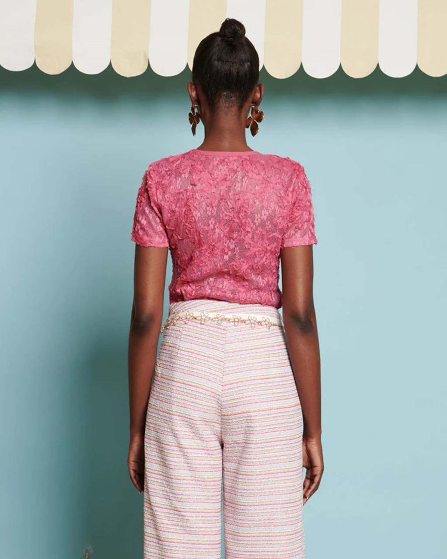 back view of model wearing hot pink top with textured floral print