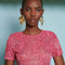 up close of model wearing hot pink top with textured floral print