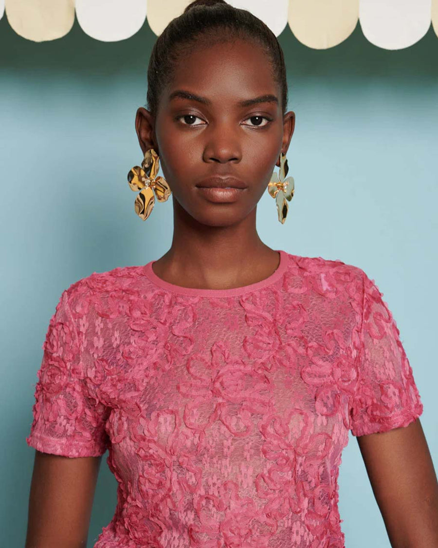 up close of model wearing hot pink top with textured floral print