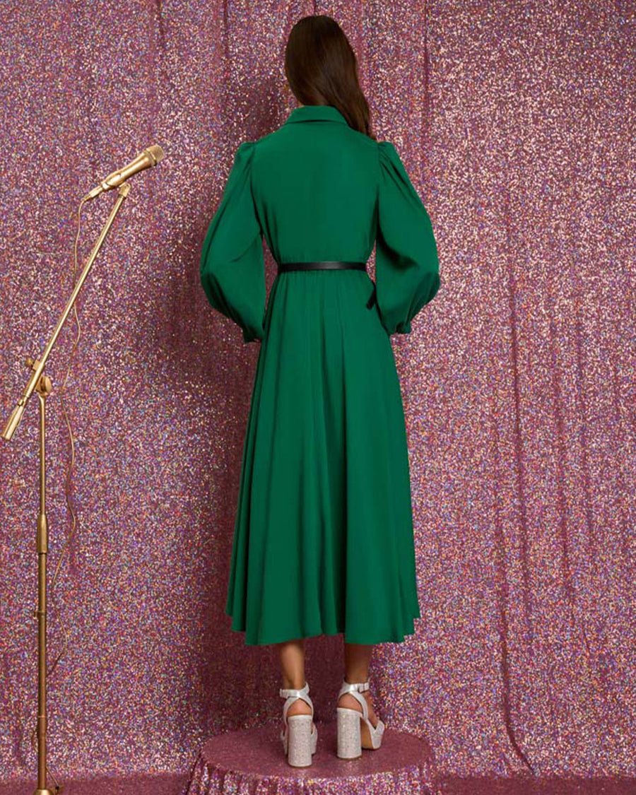 back view of model wearing emerald green midi dress with collar, long puff sleeves, decorative button front and black tie neckline