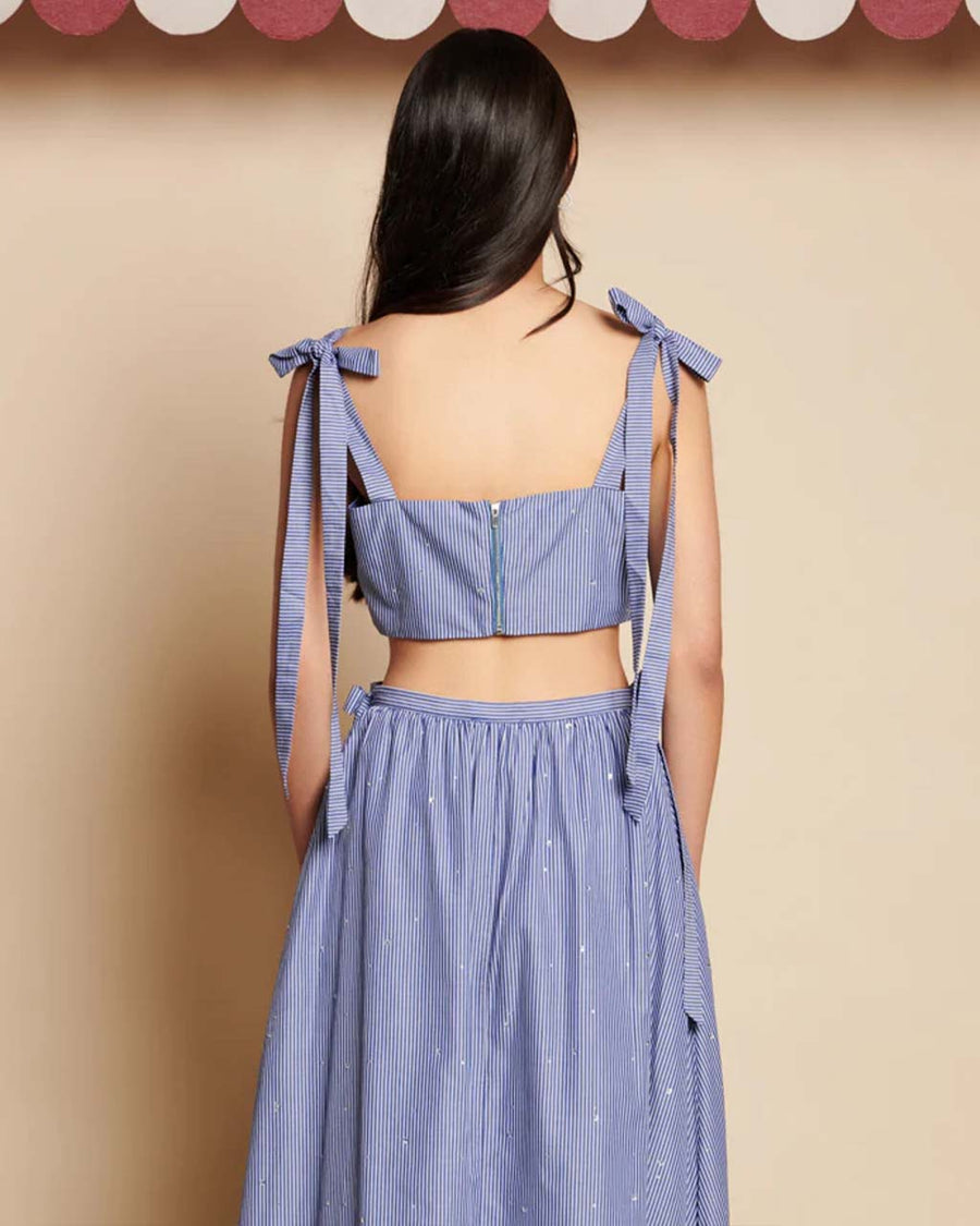 back view of model wearing blue cropped tank with stripe pattern and all over embellishments