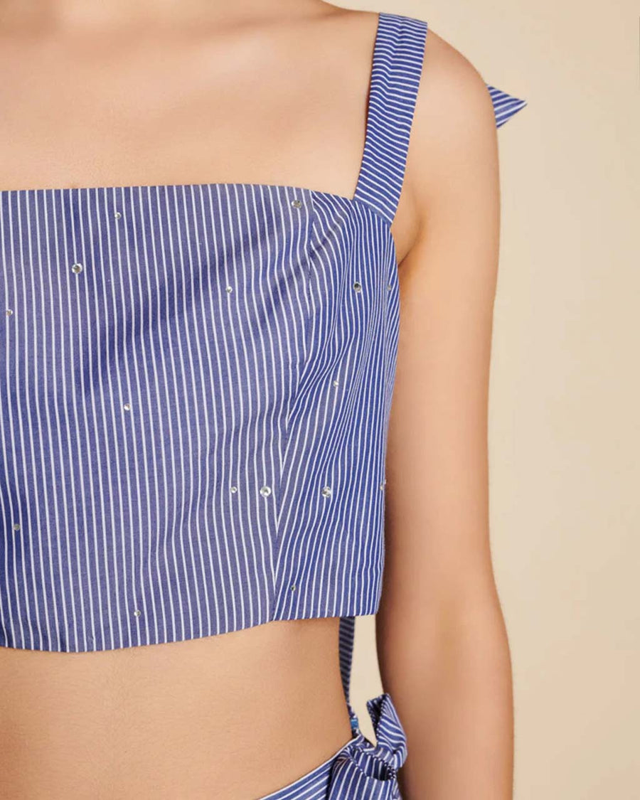up close of model wearing blue cropped tank with stripe pattern and all over embellishments