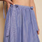 up close of model wearing blue stripe midi skirt with bows at the waist and all over embellishments