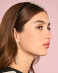 side view of model wearing velvet headband with beaded bow in the center