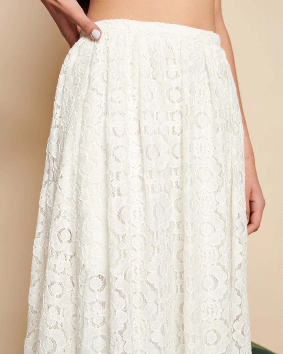 up close of model wearing white lace midi skirt