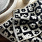 up close of black and cream checkered flower hand towel