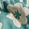 up close of cream and sky blue abstract palm tree and sun design turkish towel