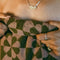 up close of model wearing olive green and muted pink flower geometric bath towel