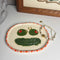 handmade tray with olive eyes and dill pickle smiley face with pink and red trim with jewelry on it