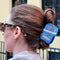 model wearing blue sardine can hair claw