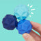 model holding set of three blue textured magnetic fidget toys