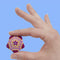 model holding various shades of purple and pink mini magnet fidget toy 