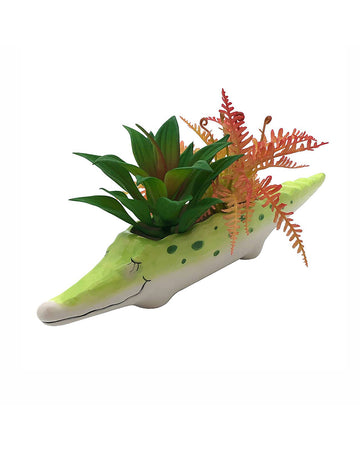 green crocodile planter with fake succulents