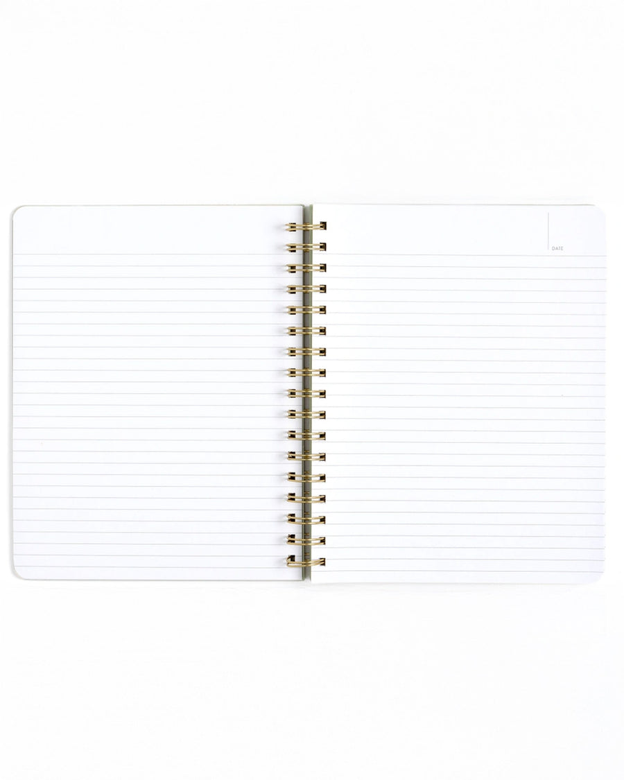 interior lined pages of green grid notebook with gold foil 'professional procrastinator' across the front
