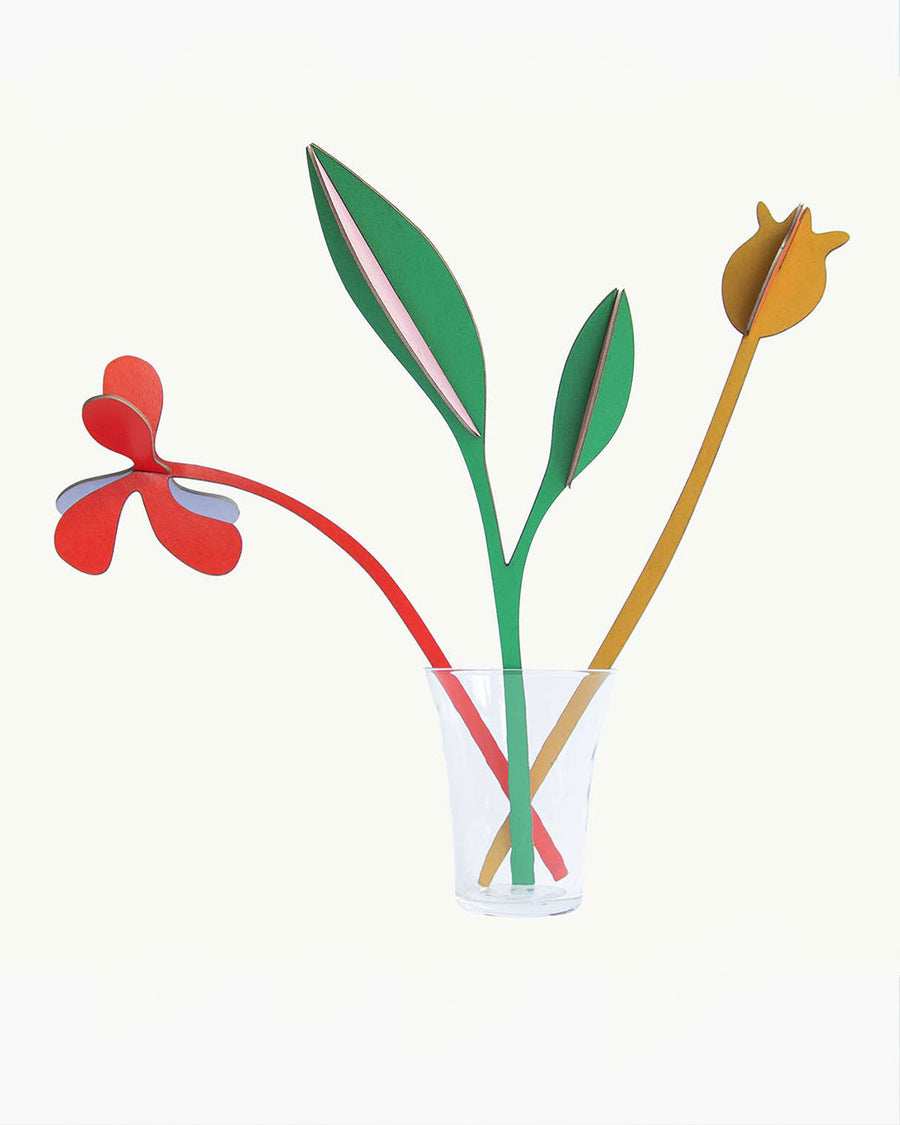 three colorful paper flowers in a vase