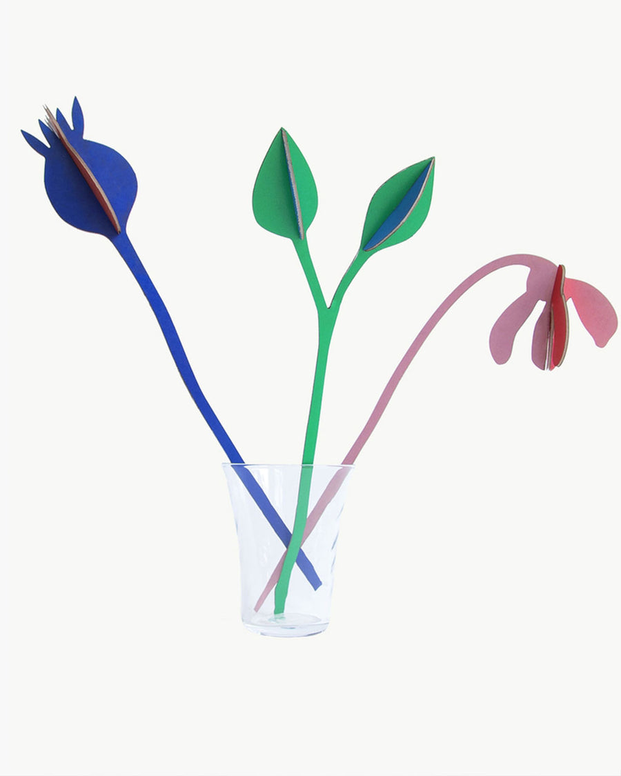 three colorful paper flowers in a vase