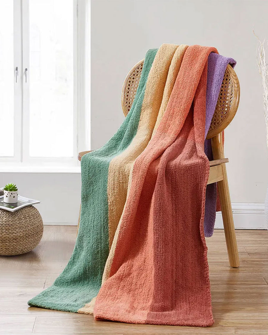 vertical rainbow throw blanket over a chair