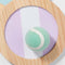 up close of purple and white and blue and white stripe catch ball set with mint colored velcro ball