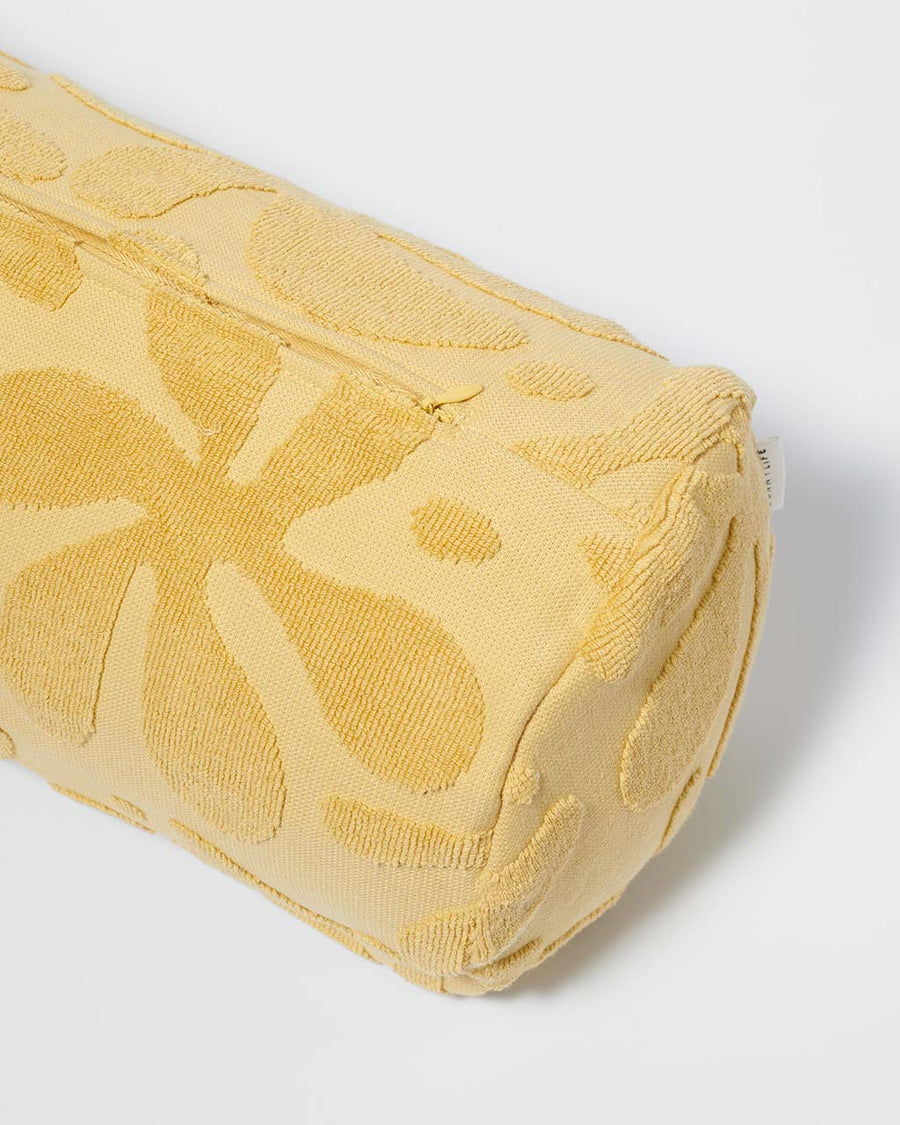 up close of gold mustard textured floral inflatable beach pillow