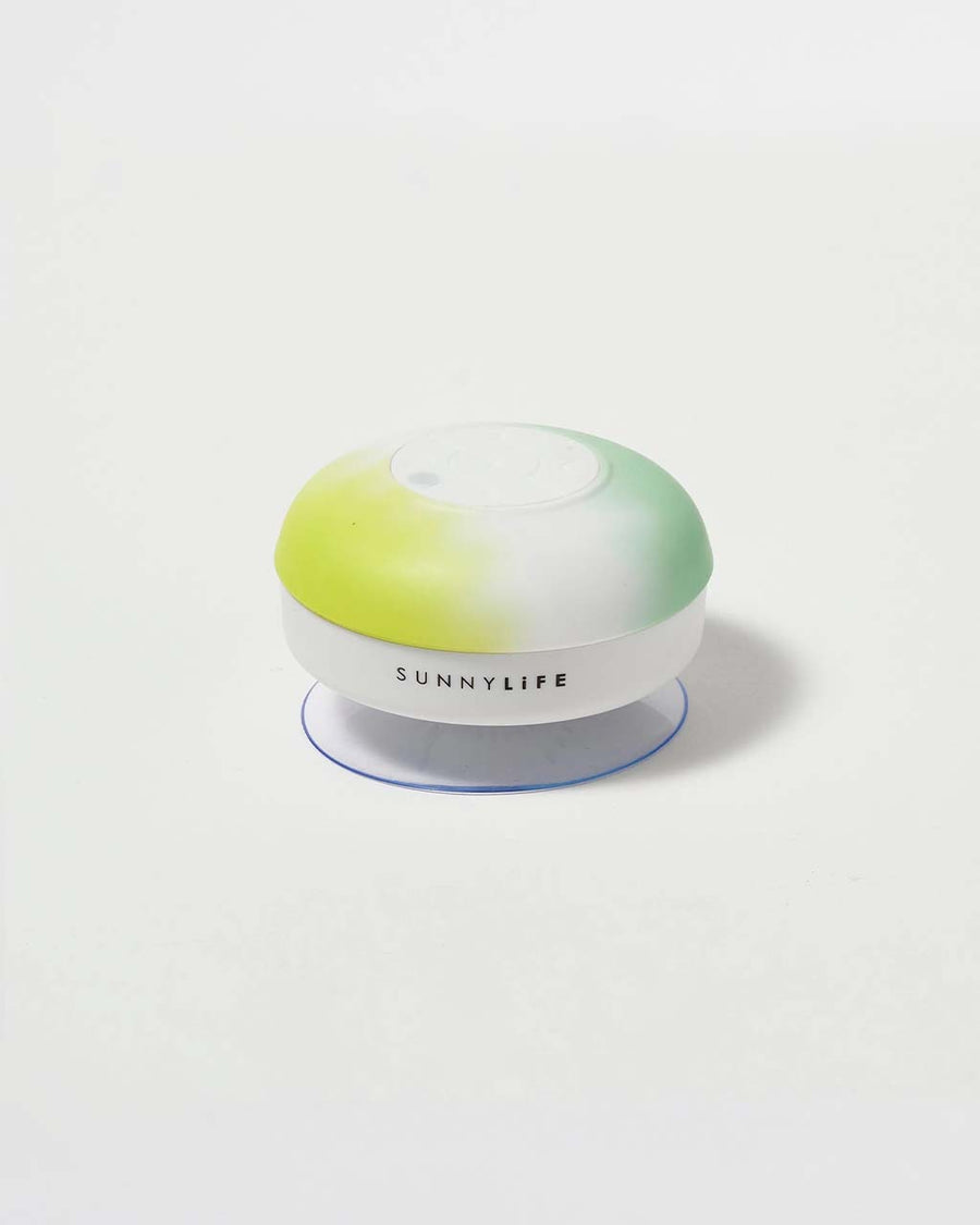side view of yellow, white and green circular waterproof speaker with suction bottom