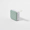 side view of green and white checkerboard travel speaker with band