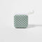 green and white checkerboard travel speaker with band