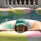 model floating on cream pool ring with pastel green, blue, orange and pink sun beams