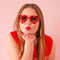 model wearing red heart shaped sunglasses