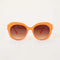 orange round sunglasses with brown lenses