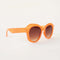 side view of orange round sunglasses with brown lenses