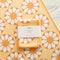 yellow kitchen towel with white 70's inspired flower print
